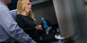 A woman and man are using a machine 